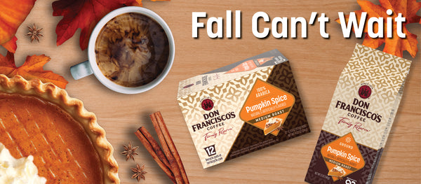 Two boxes of Don Francisco's Coffee Pumpkin Spice flavor are displayed on a wooden table alongside a cup of coffee, a pumpkin pie, cinnamon sticks, and autumn leaves, with the text 'Fall Can't Wait' at the top.